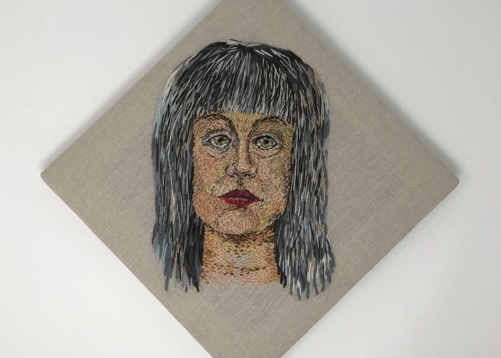 Catherine Hicks: 1st Self Portrait in Wool, 2014, 17” X 17”, Found wool hand embroidery on linen