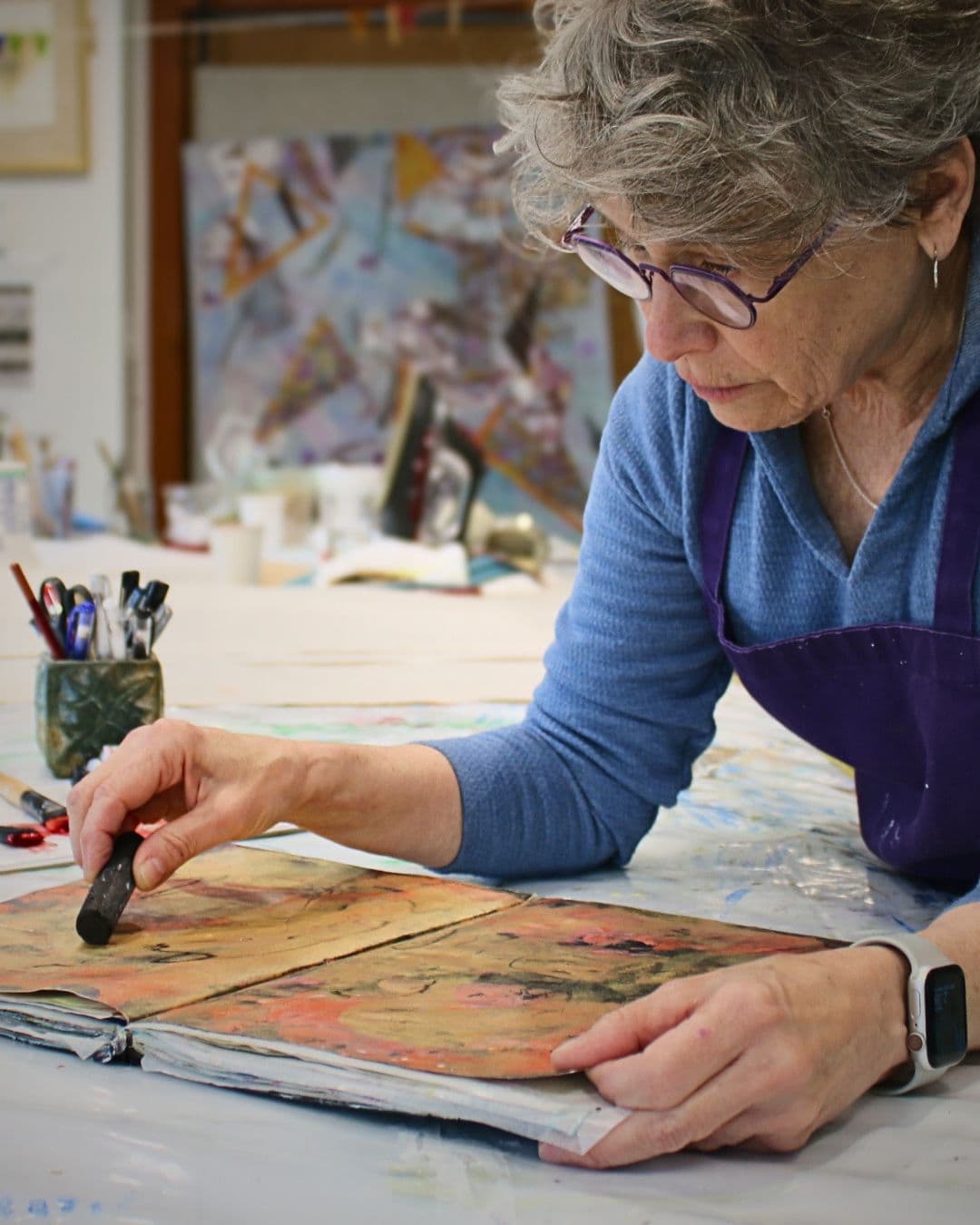 Cheryl Rezendes working on a book in her studio