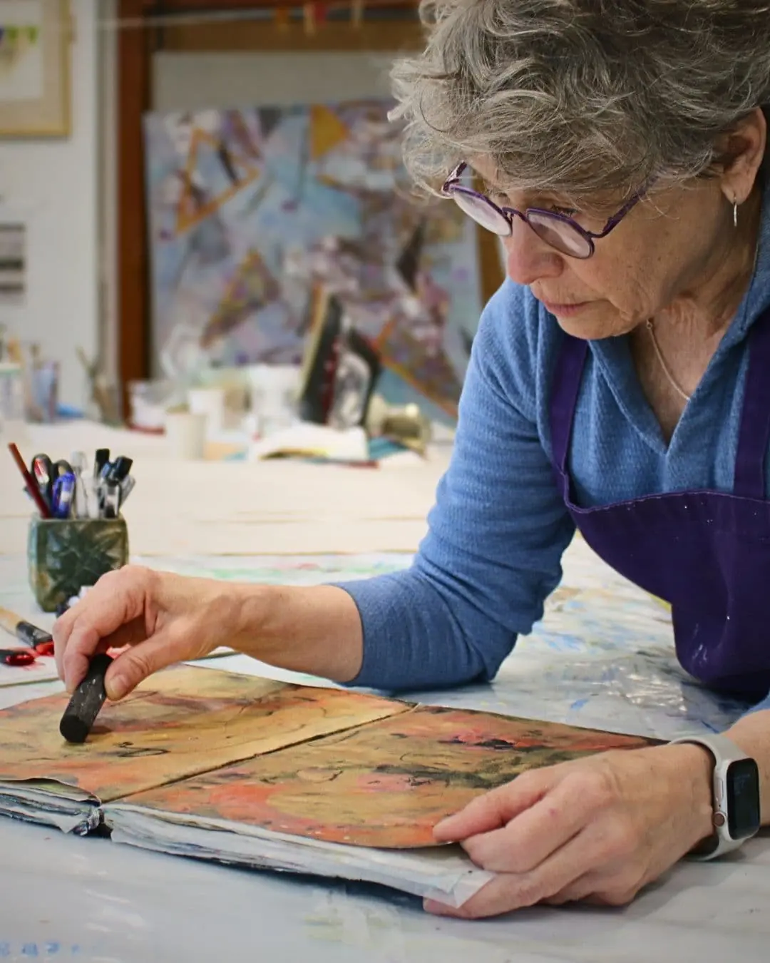 Cheryl Rezendes working on a book in her studio