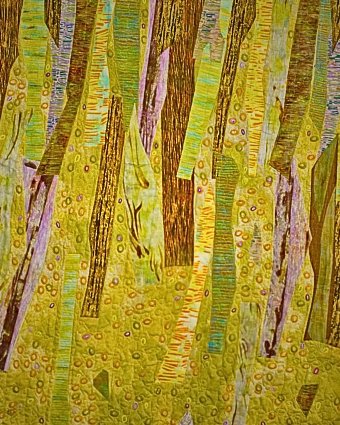 Trees created through monoprinting, machine quilting & stamping.