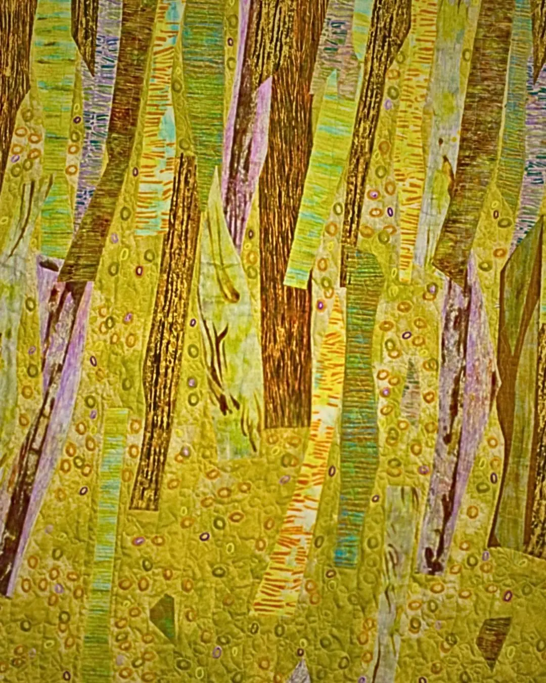 Trees created through monoprinting, machine quilting & stamping.