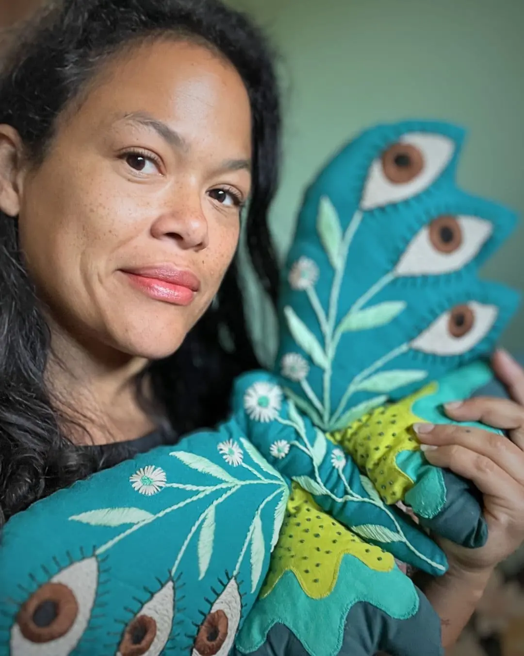 Textile Artist Christi Johnson holding an stuffed moth