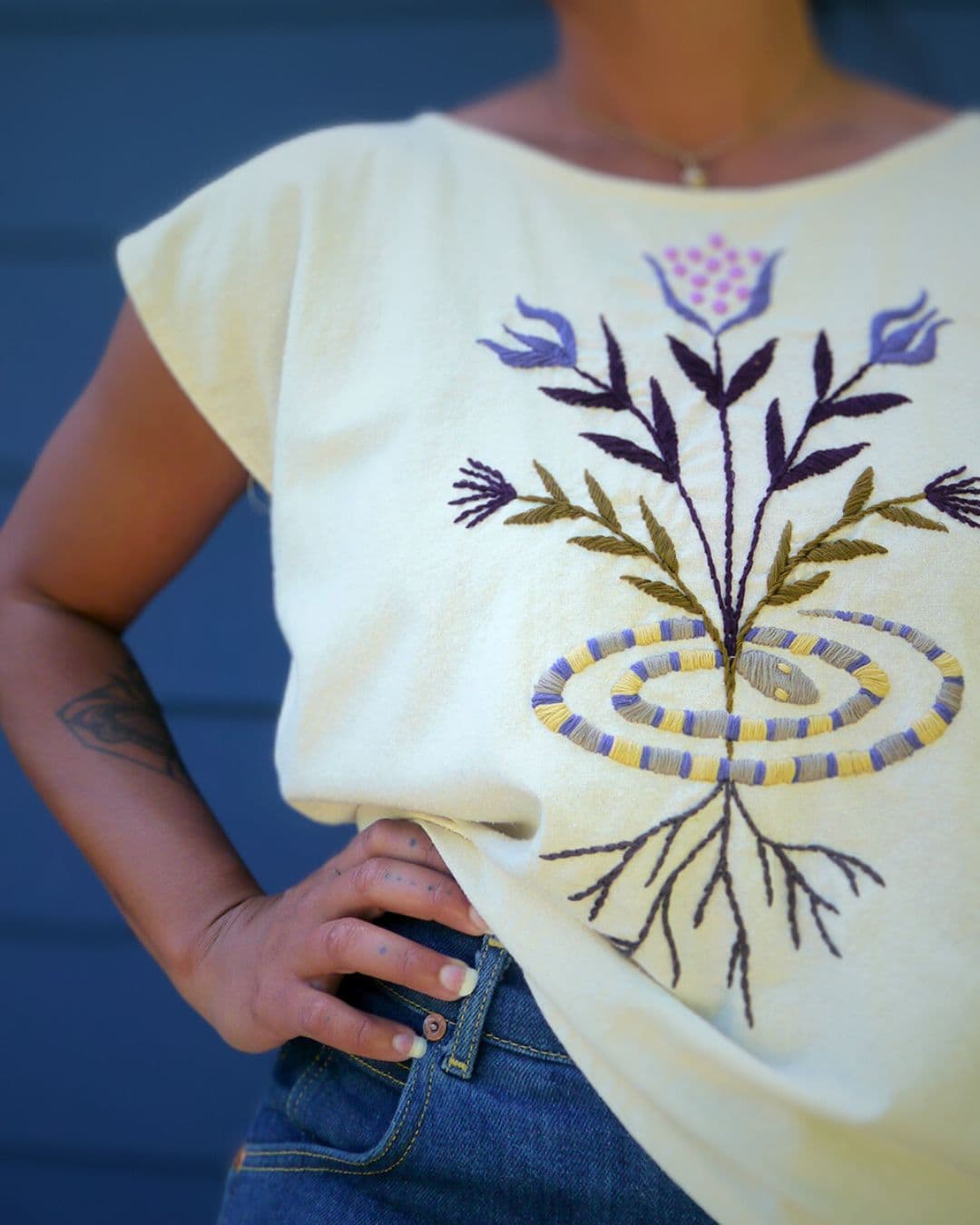 White top with an embroidered flower design