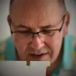 A close up image of textile artist Darren Ball working at his sewing machine.