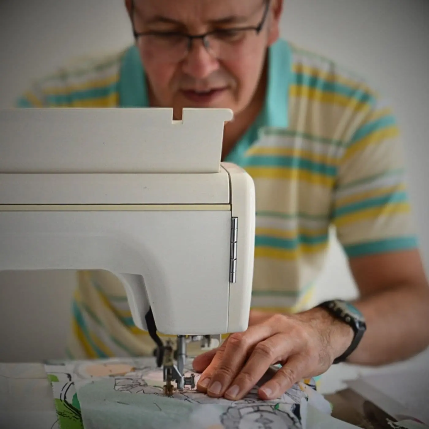 Darren Ball, working at his sewing machine.