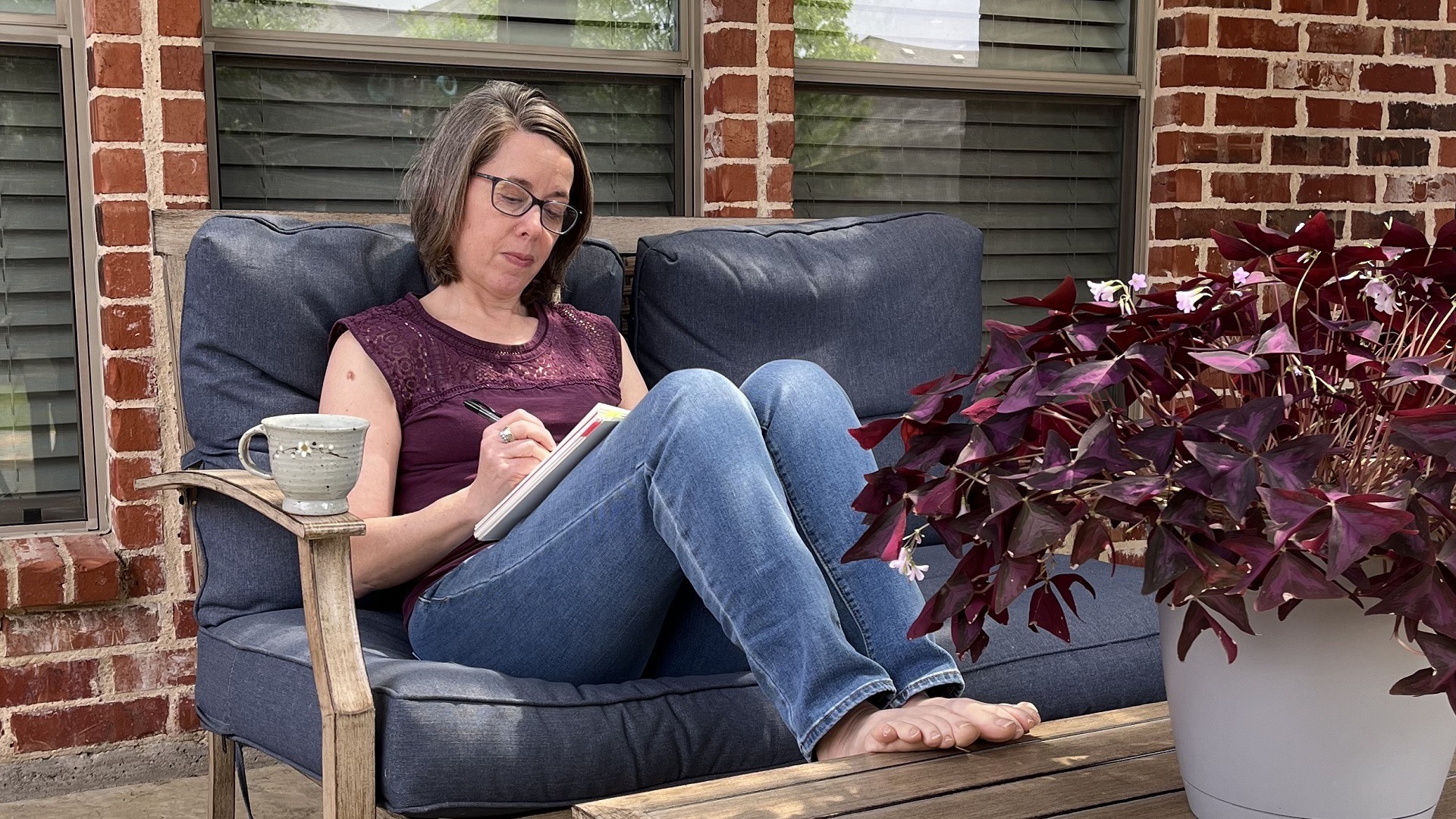 Textile Artist Deborah Boschert sketching on the patio.
