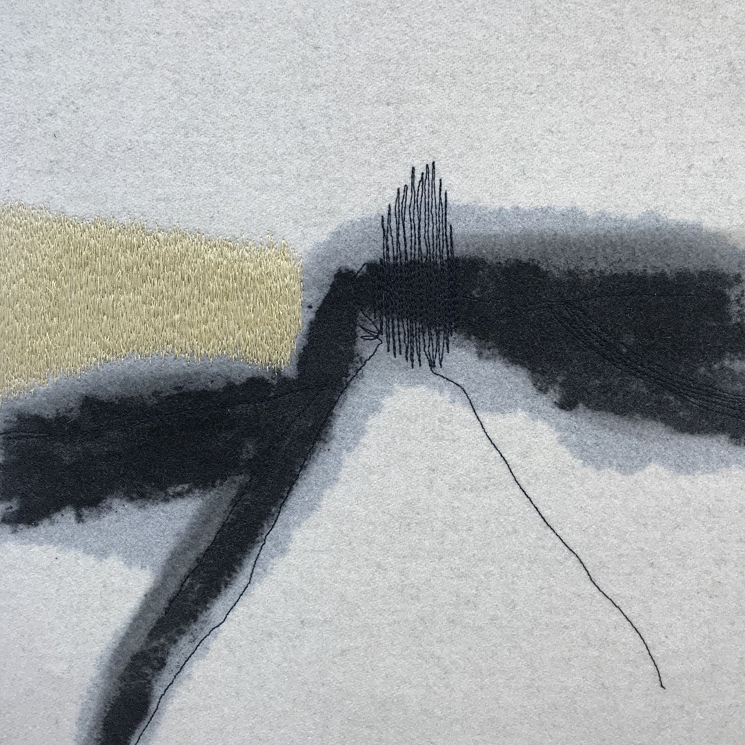 Abstract textile art piece with a line