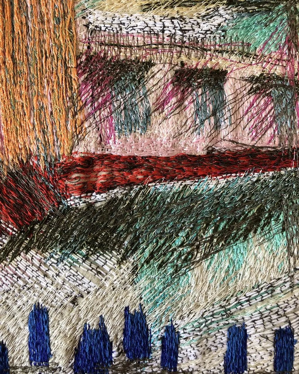 A close up of an abstract textile art piece