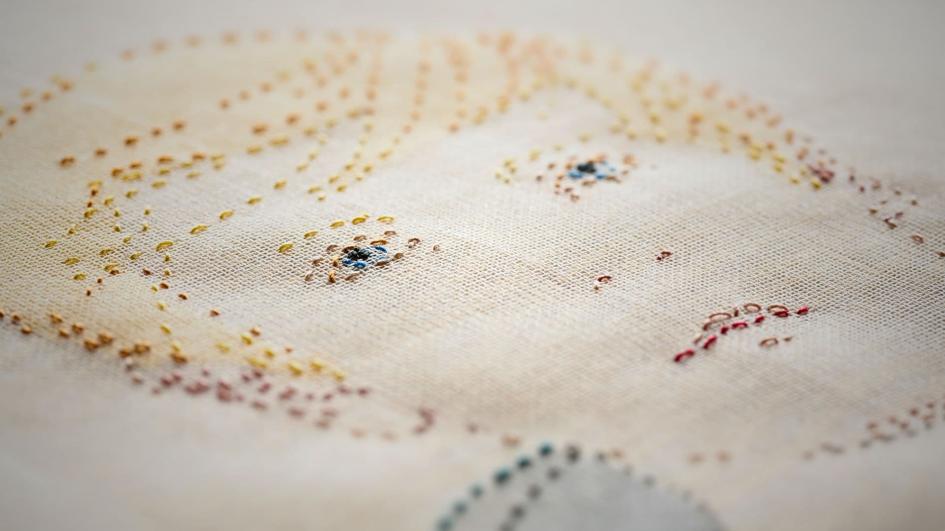 A textile artwork of a boys face.