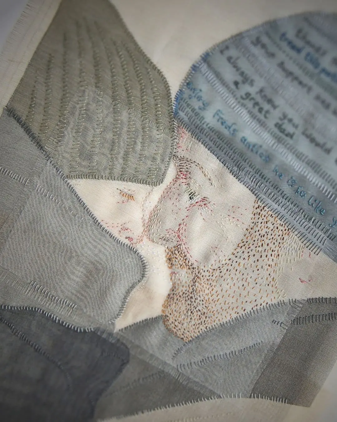 Textile artwork of a man and boy.