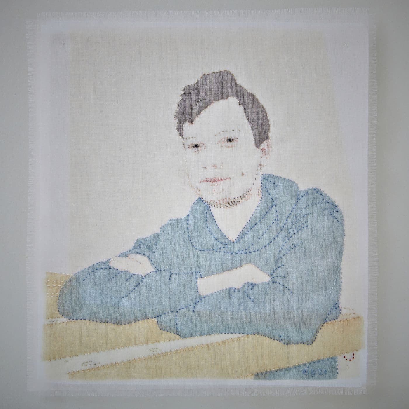 Textile stitched artwork of a boy.