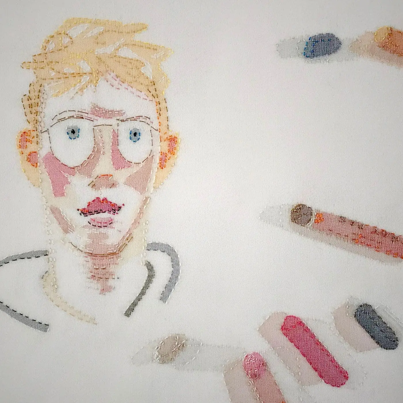 Stitched textile artwork of a boy & oil pastels.