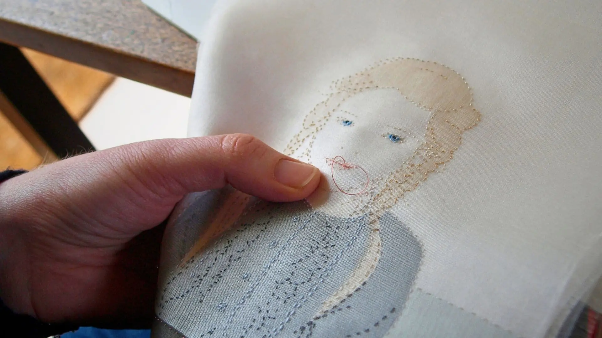 Handstitched artwork of a woman.