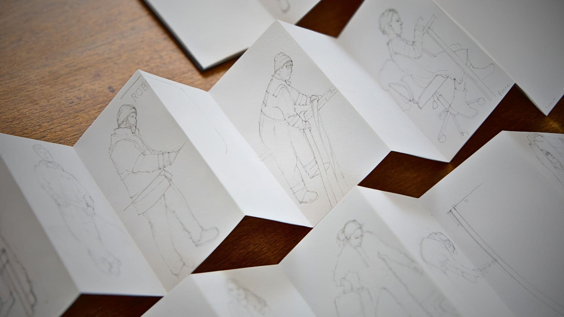 Sketches of people in an accordion format.