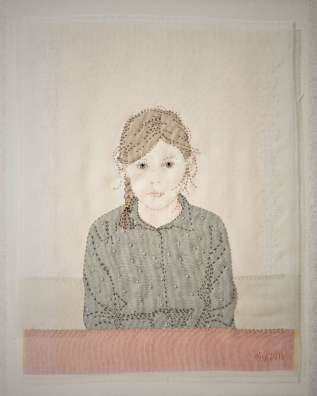 A handstitched artwork of a girl.