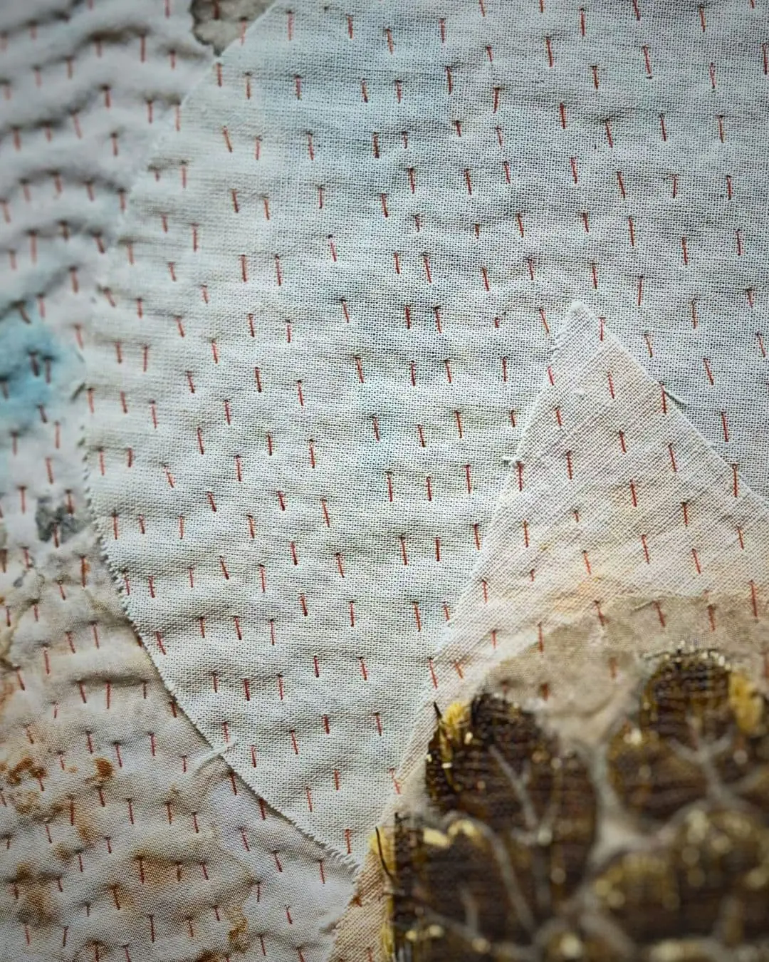 A close up of a stitched artwork