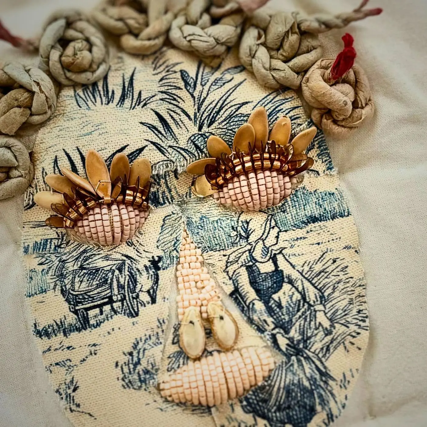 A 3D face made of embroidery and mixed media