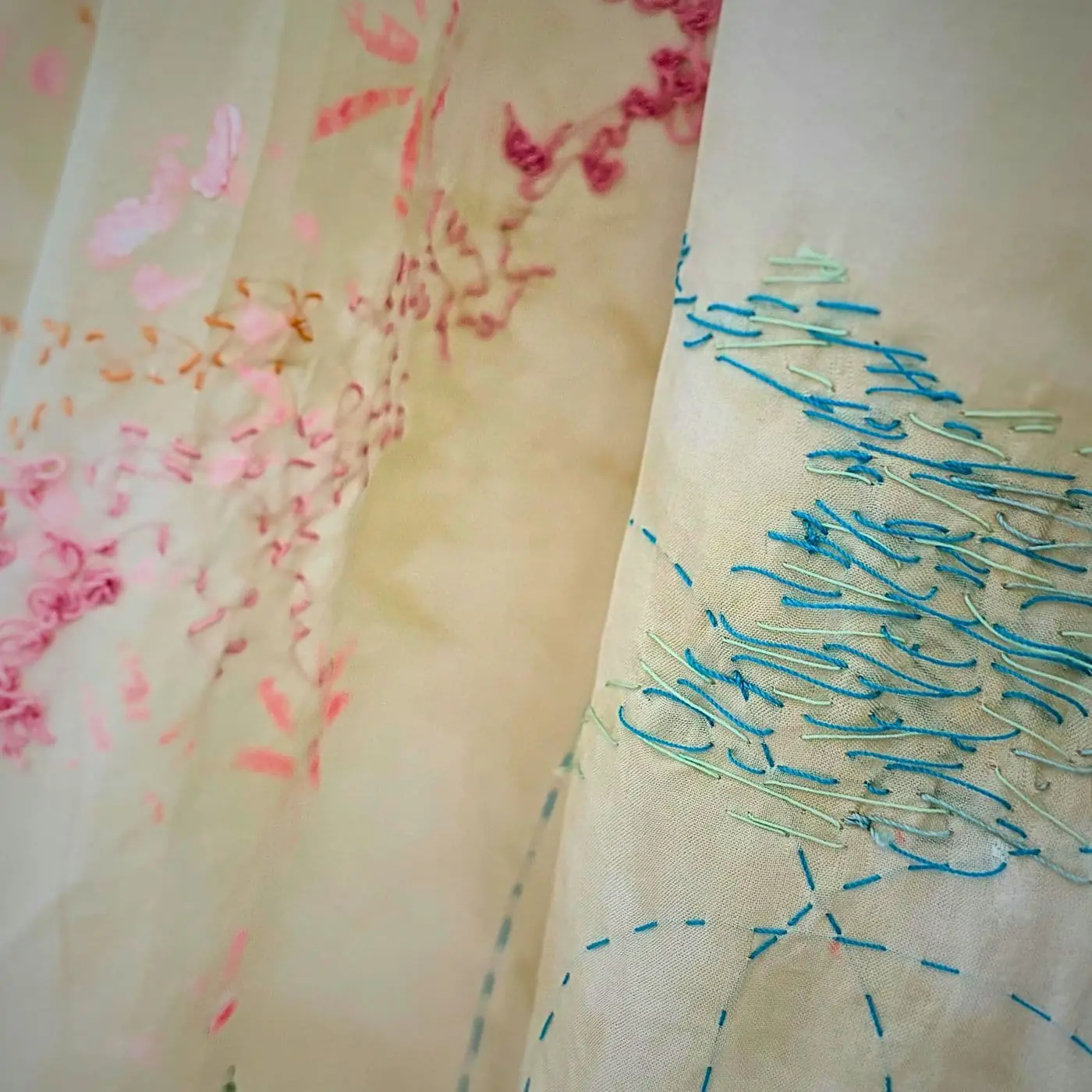 A close up of a silk embroidered curtain