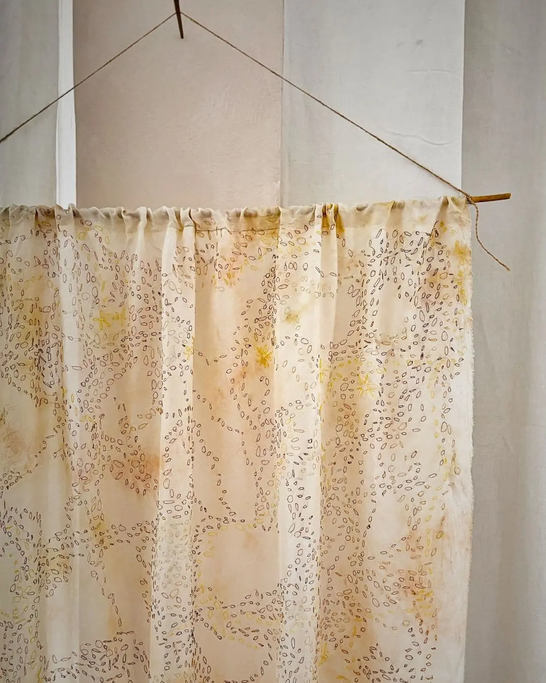 A silk curtain hanging on a stick