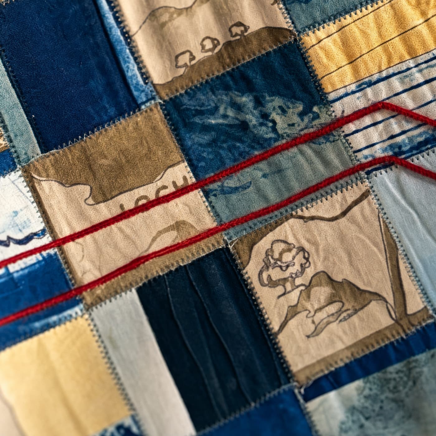Colourful patchwork fabric with stitching.