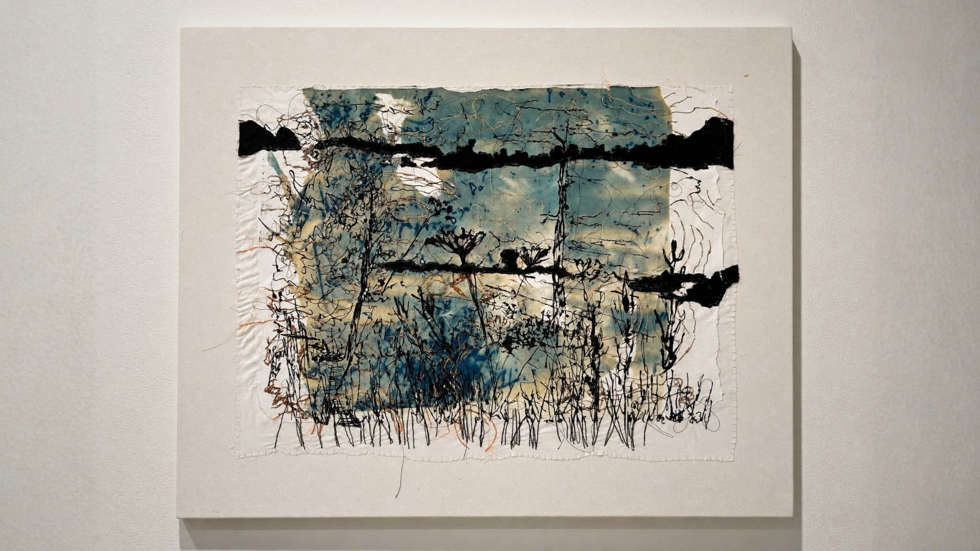 Abstract landscape with stitched elements.