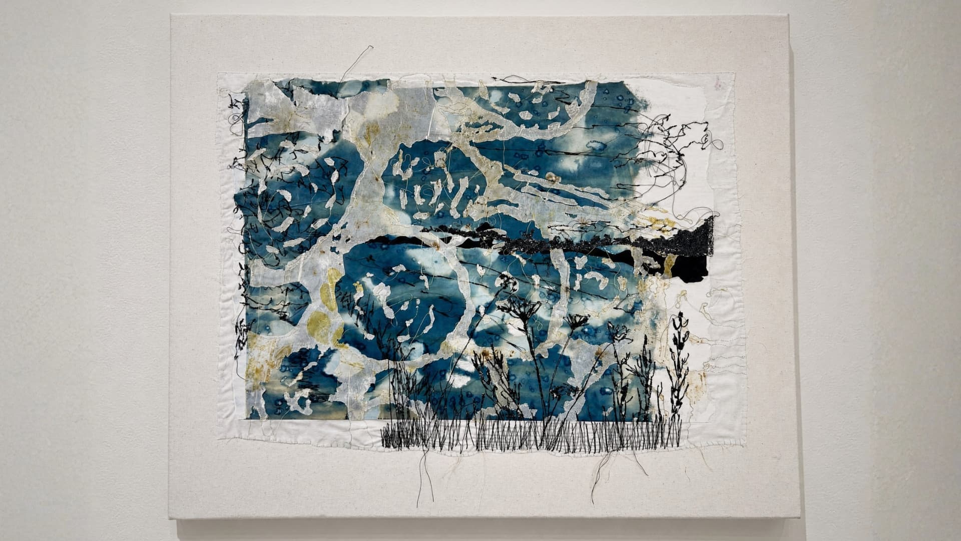 Abstract textile artwork with blue tones.