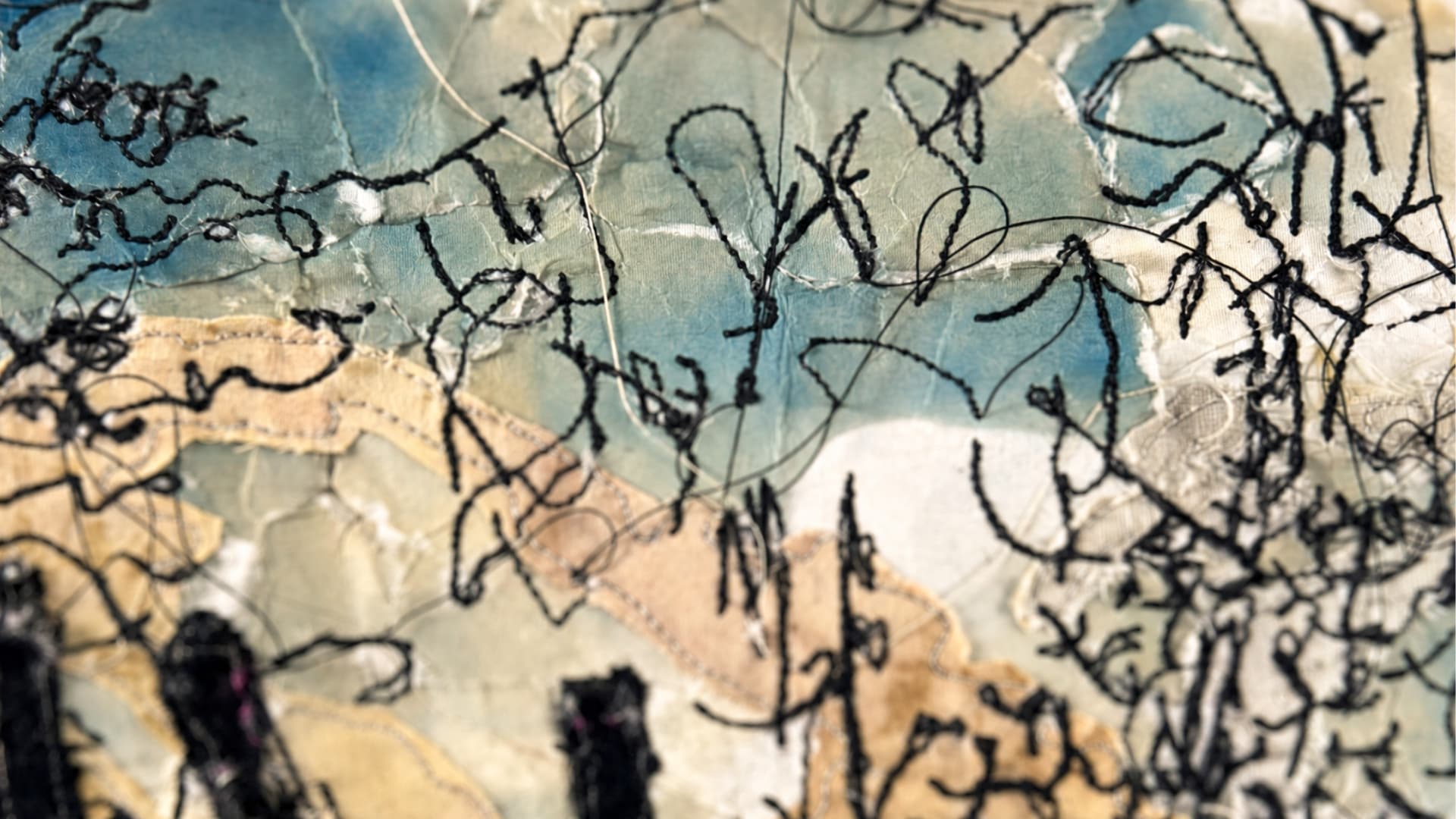 Abstract stitching on textured background.