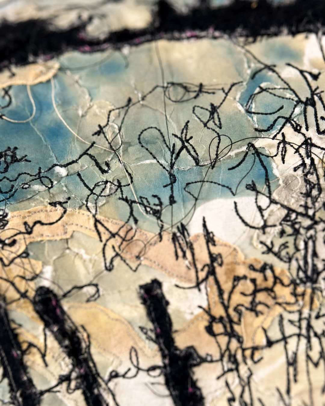 Abstract textile art with intricate stitching