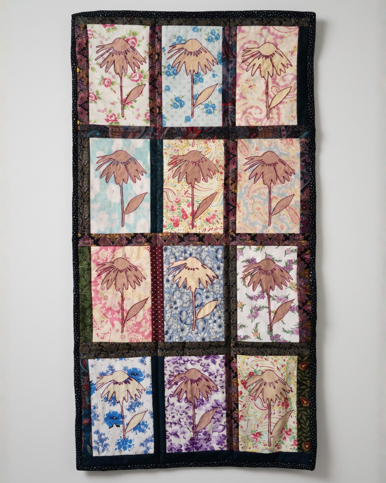 Colourful quilt featuring floral patterns.