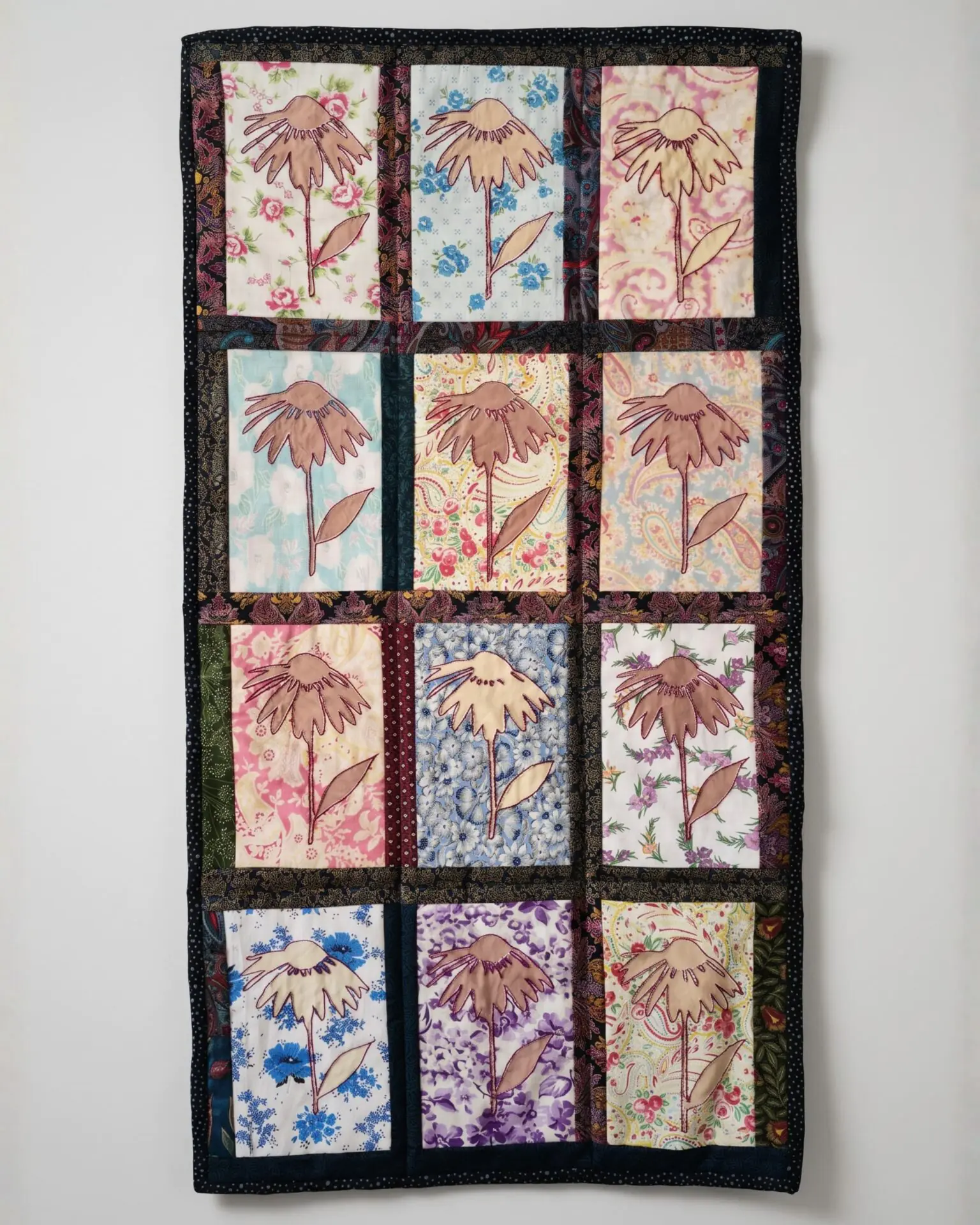 Colourful quilt featuring floral patterns.