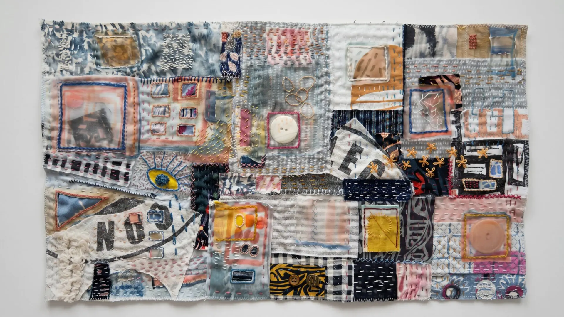 Colourful textile collage with various patterns.