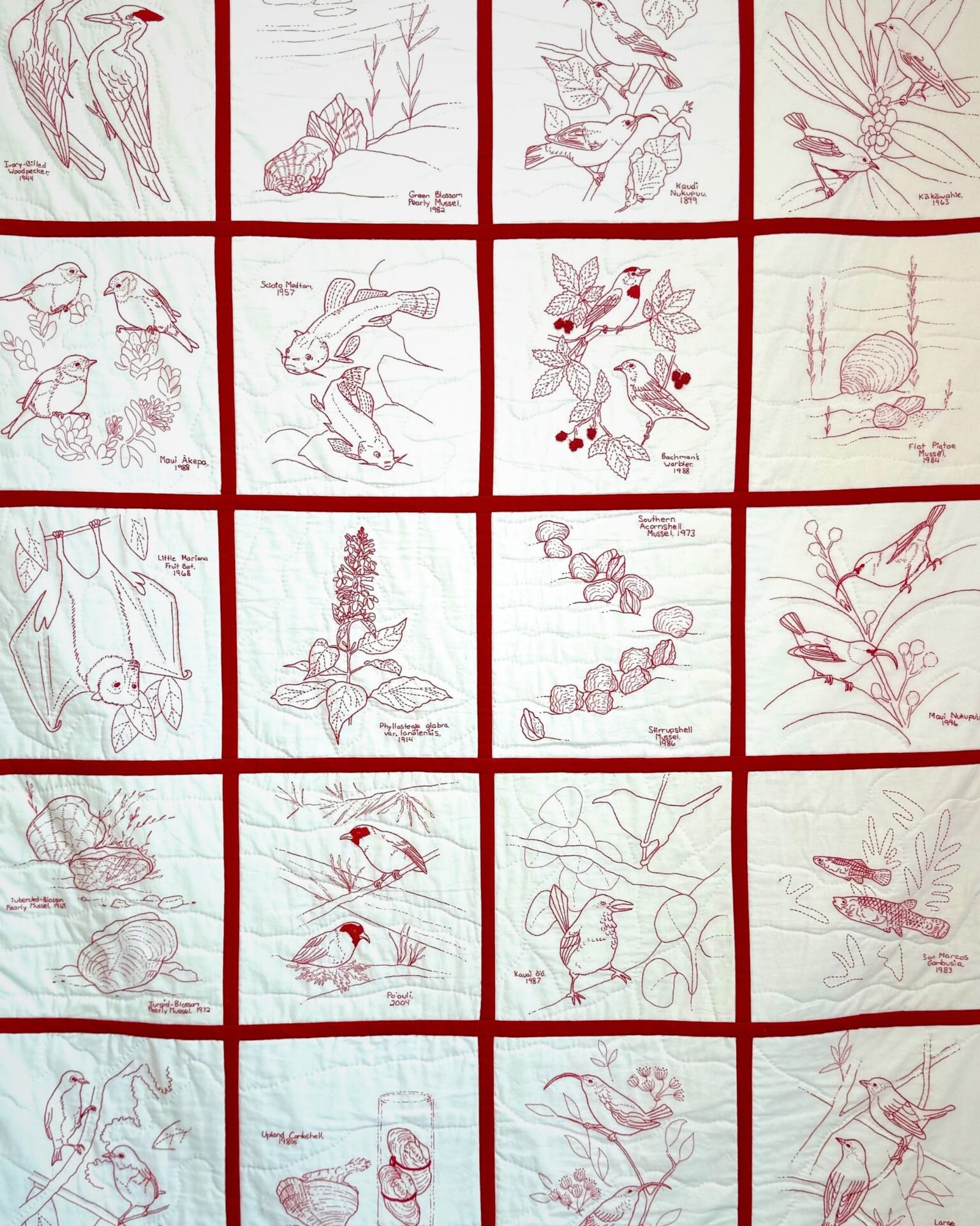 Red and white embroidered nature scenes