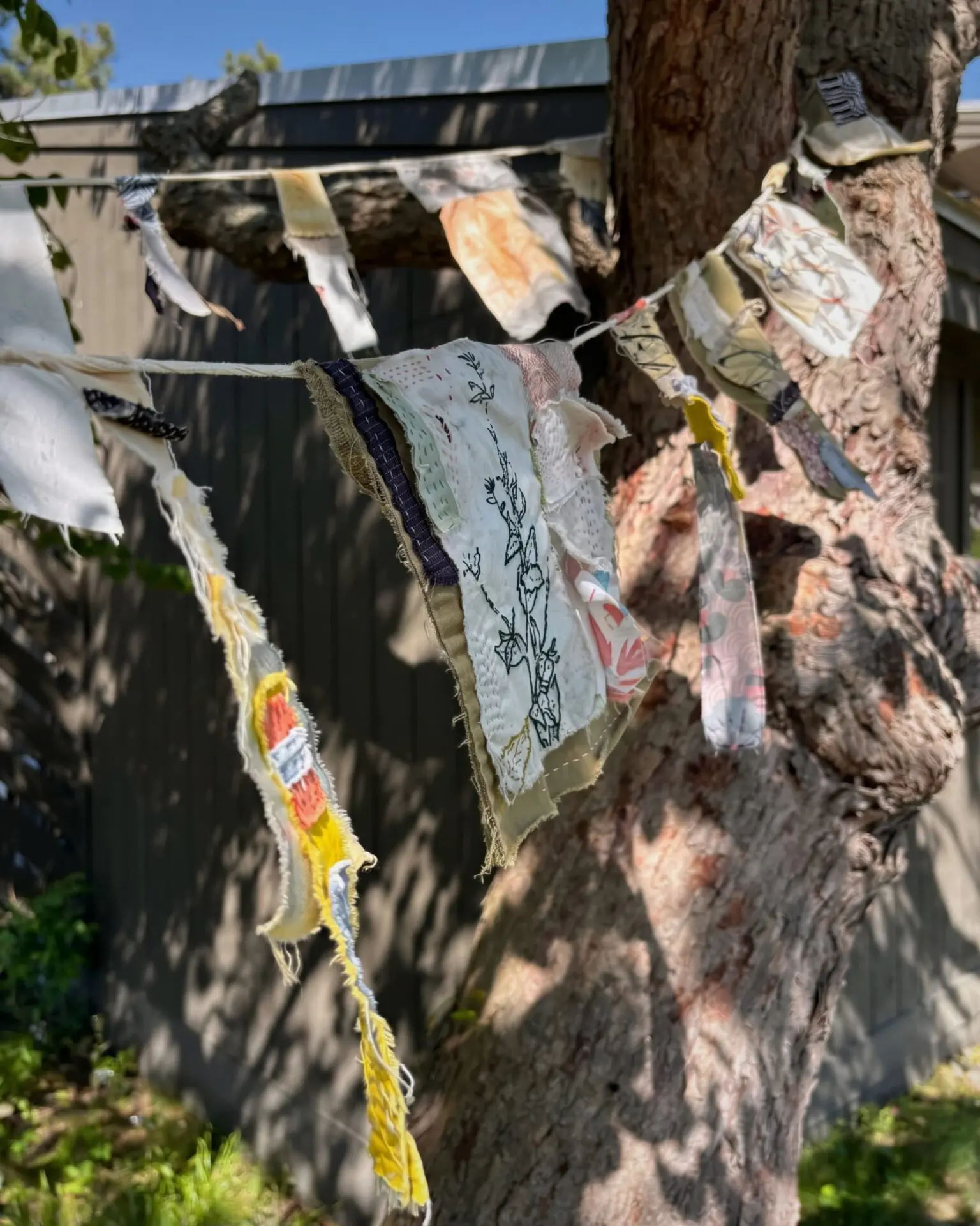 Colourful fabric banners hanging outdoors.