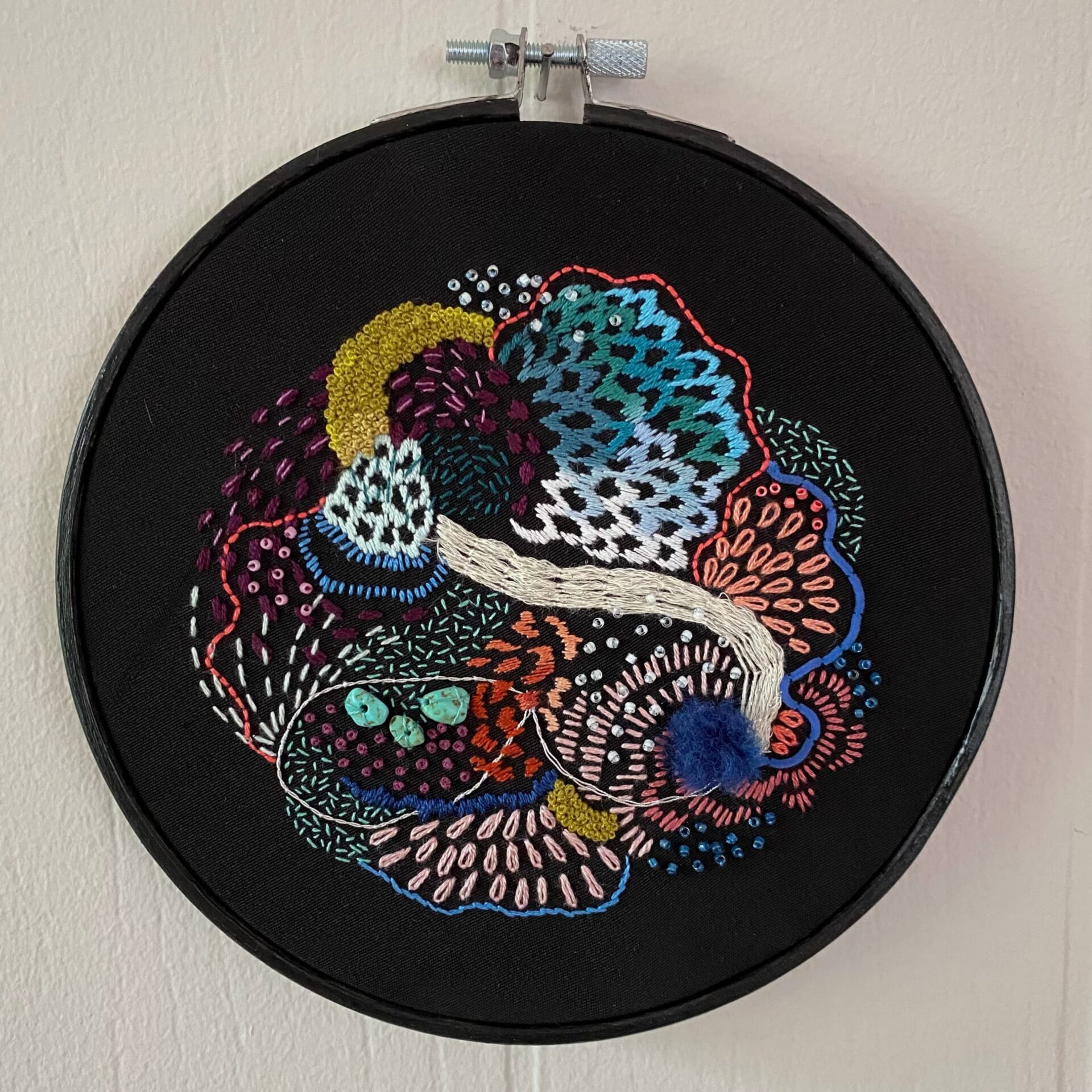 Vibrant abstract embroidery on black