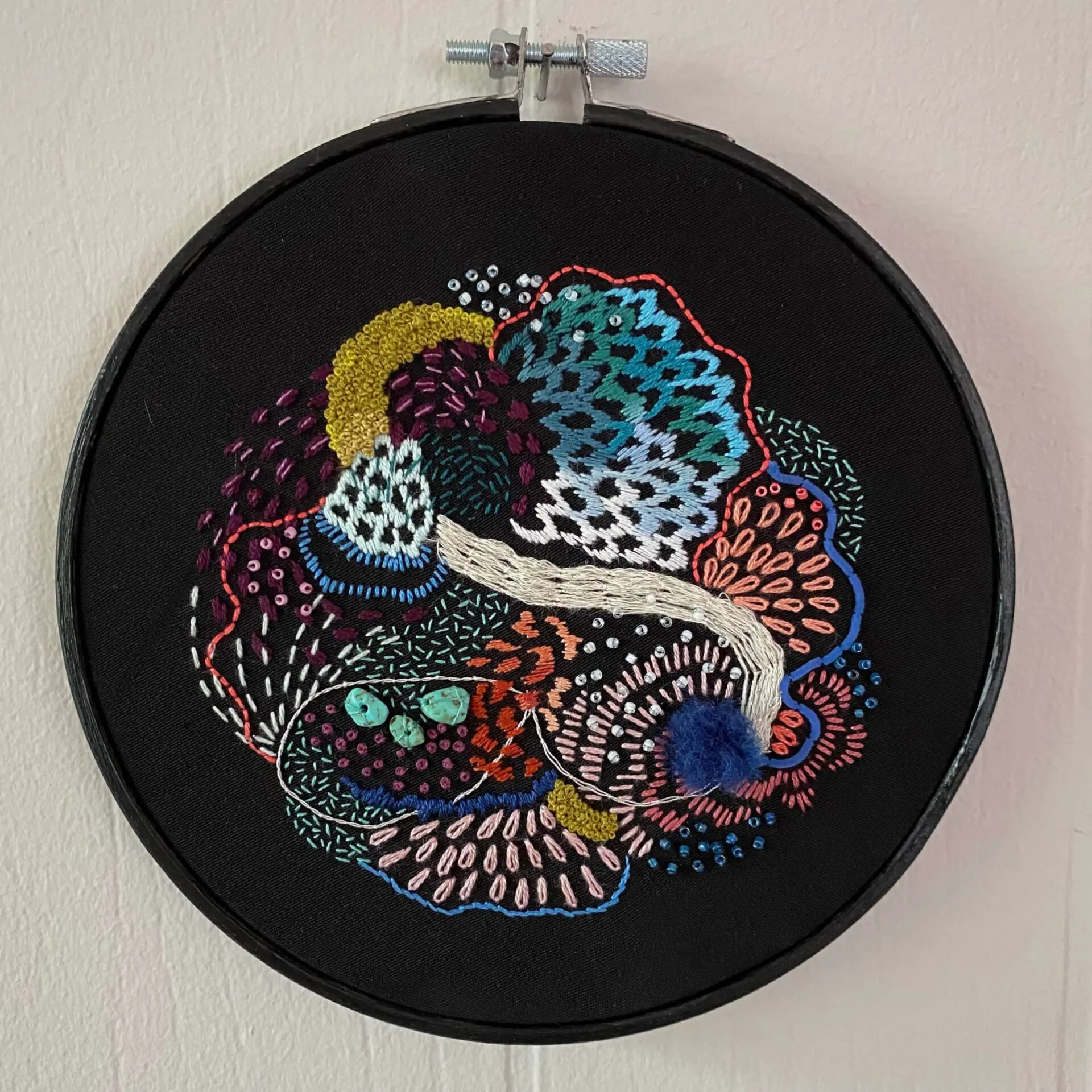Vibrant abstract embroidery on black