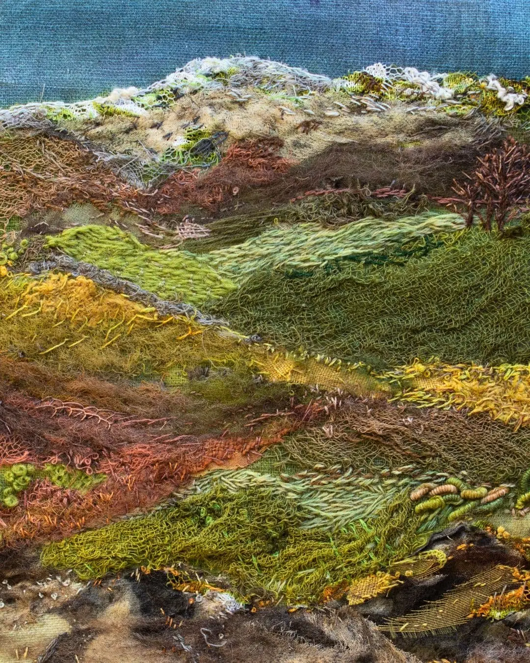 A close up of a stitched artwork of Loch Tay.