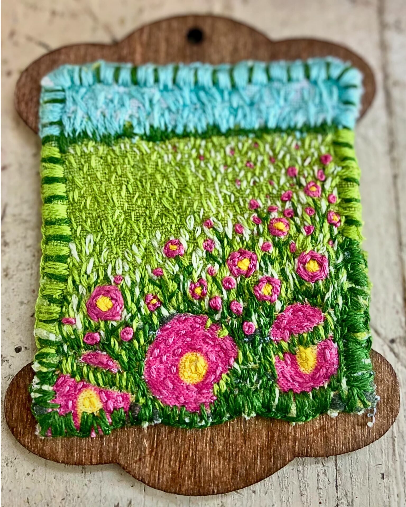Colourful embroidered meadow with flowers.