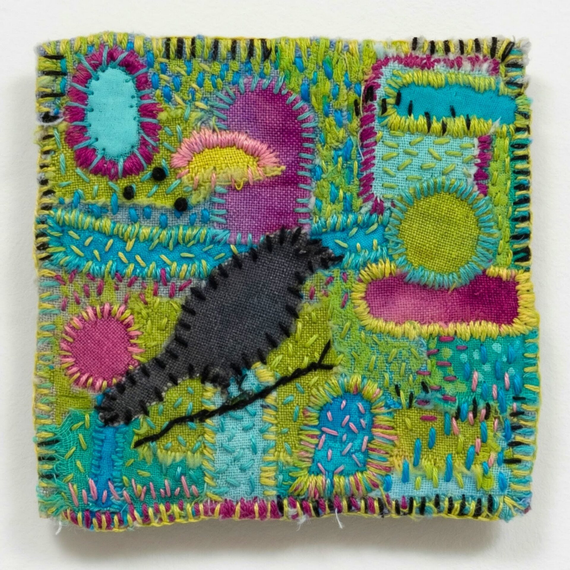 Colourful textile artwork featuring a bird