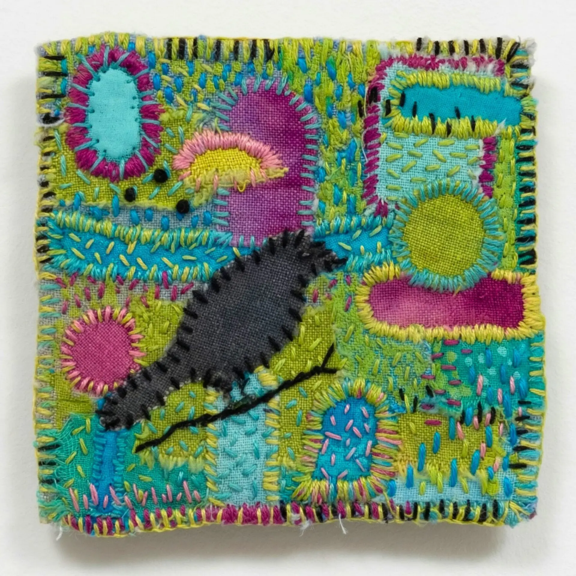 Colourful textile artwork featuring a bird