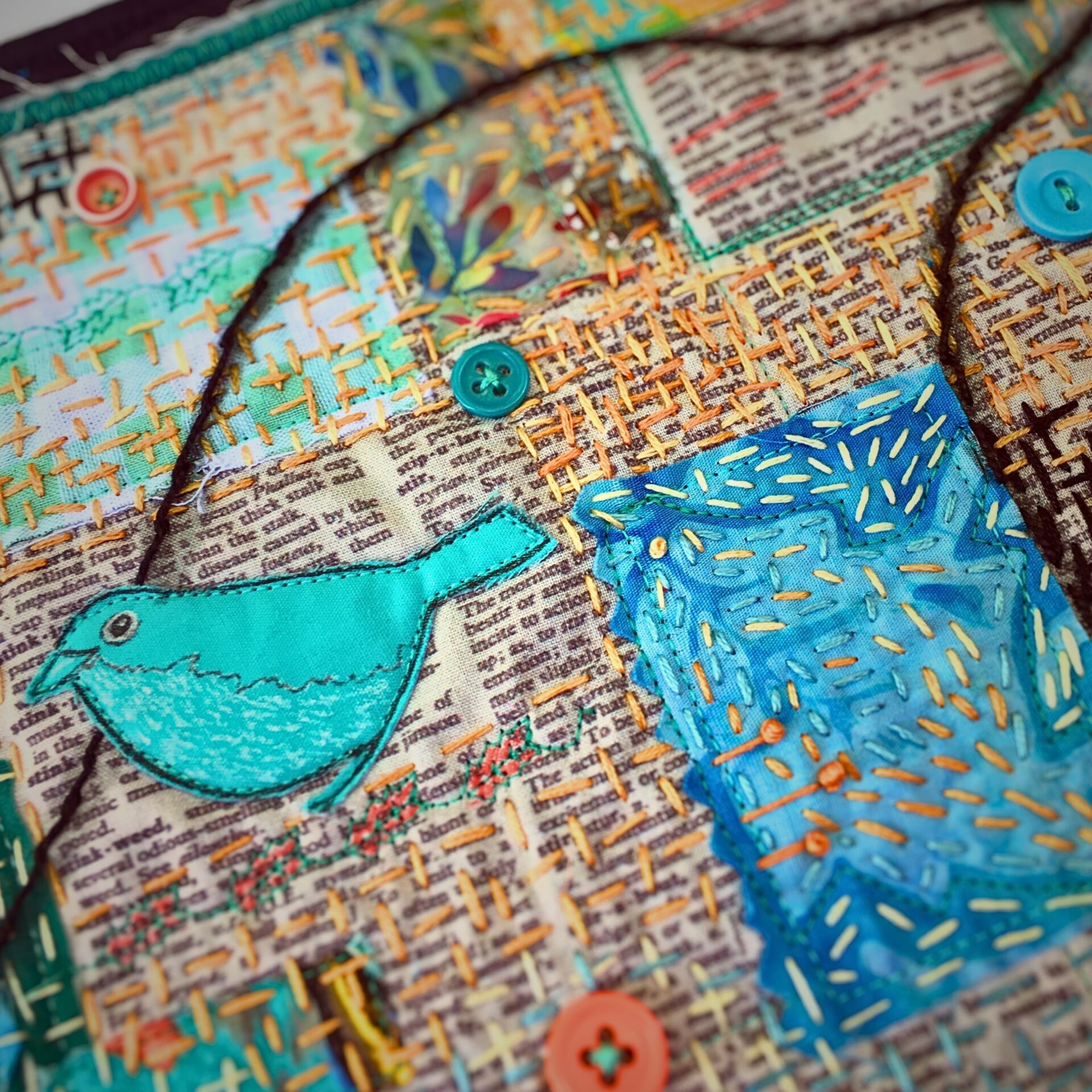 Colourful embroidery with bird and fabric