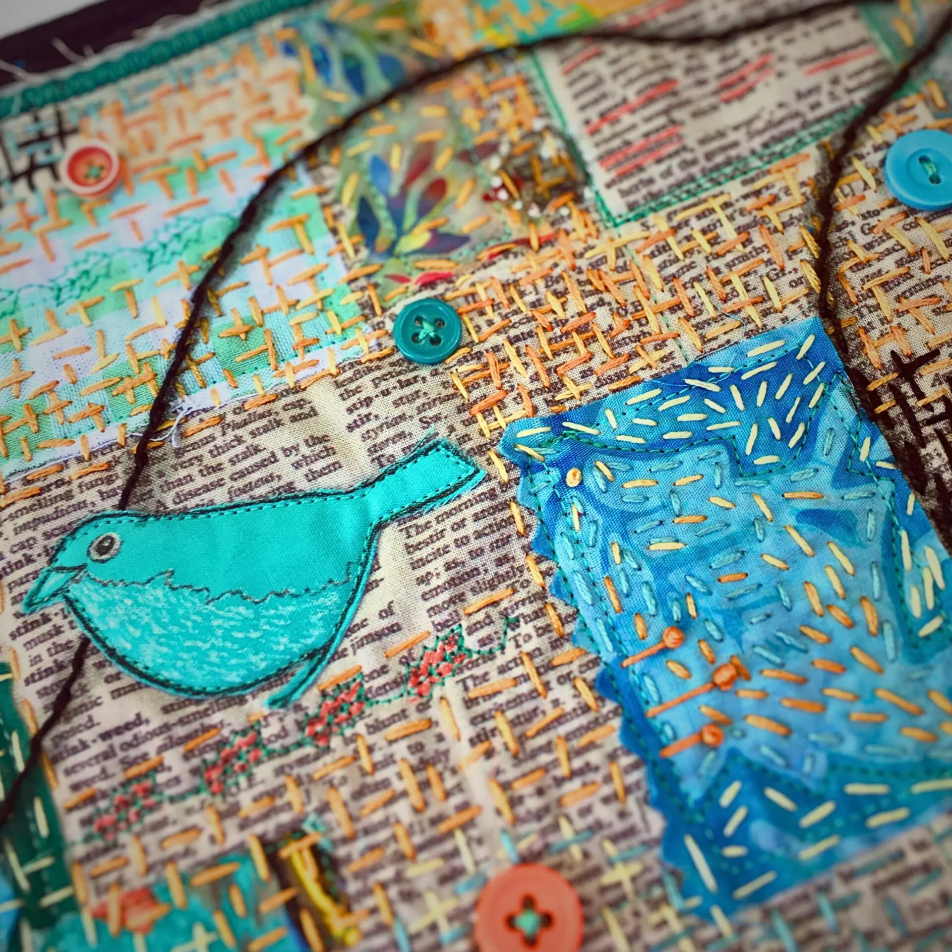 Colourful embroidery with bird and fabric