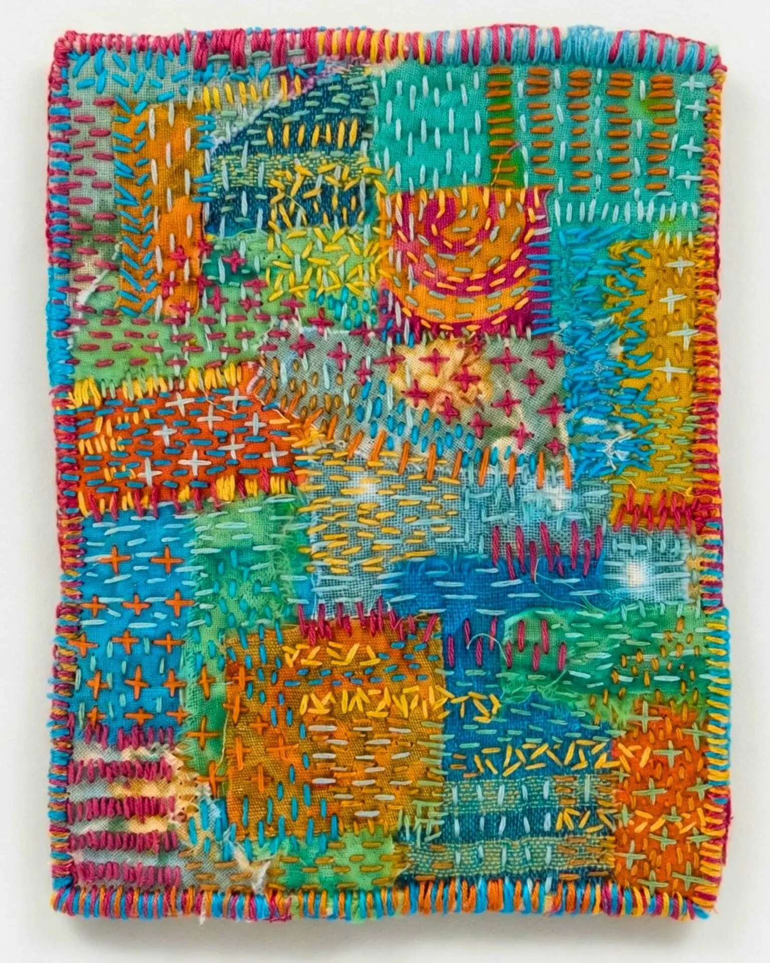Colourful textile art with intricate stitching