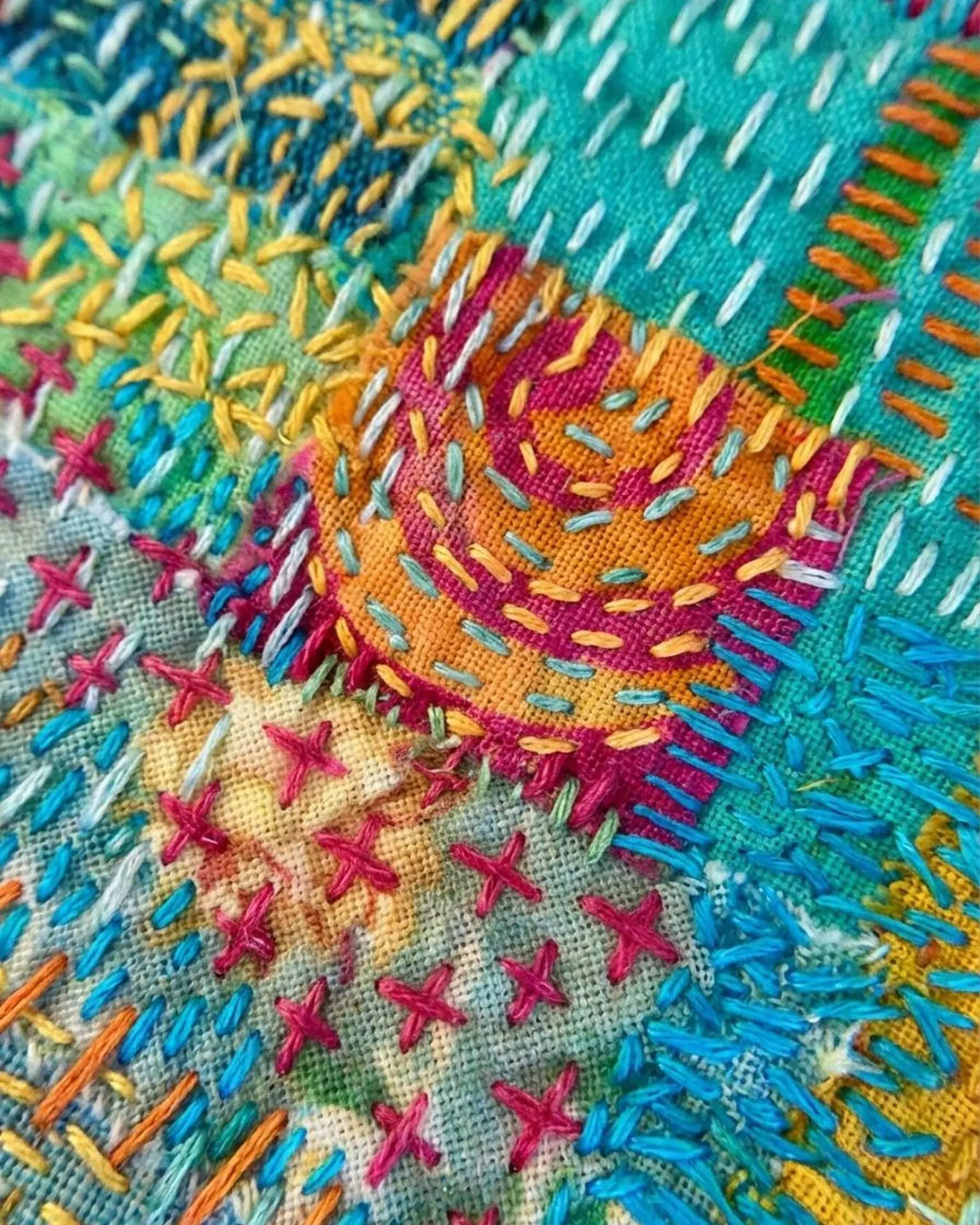 Colourful embroidered textile close up