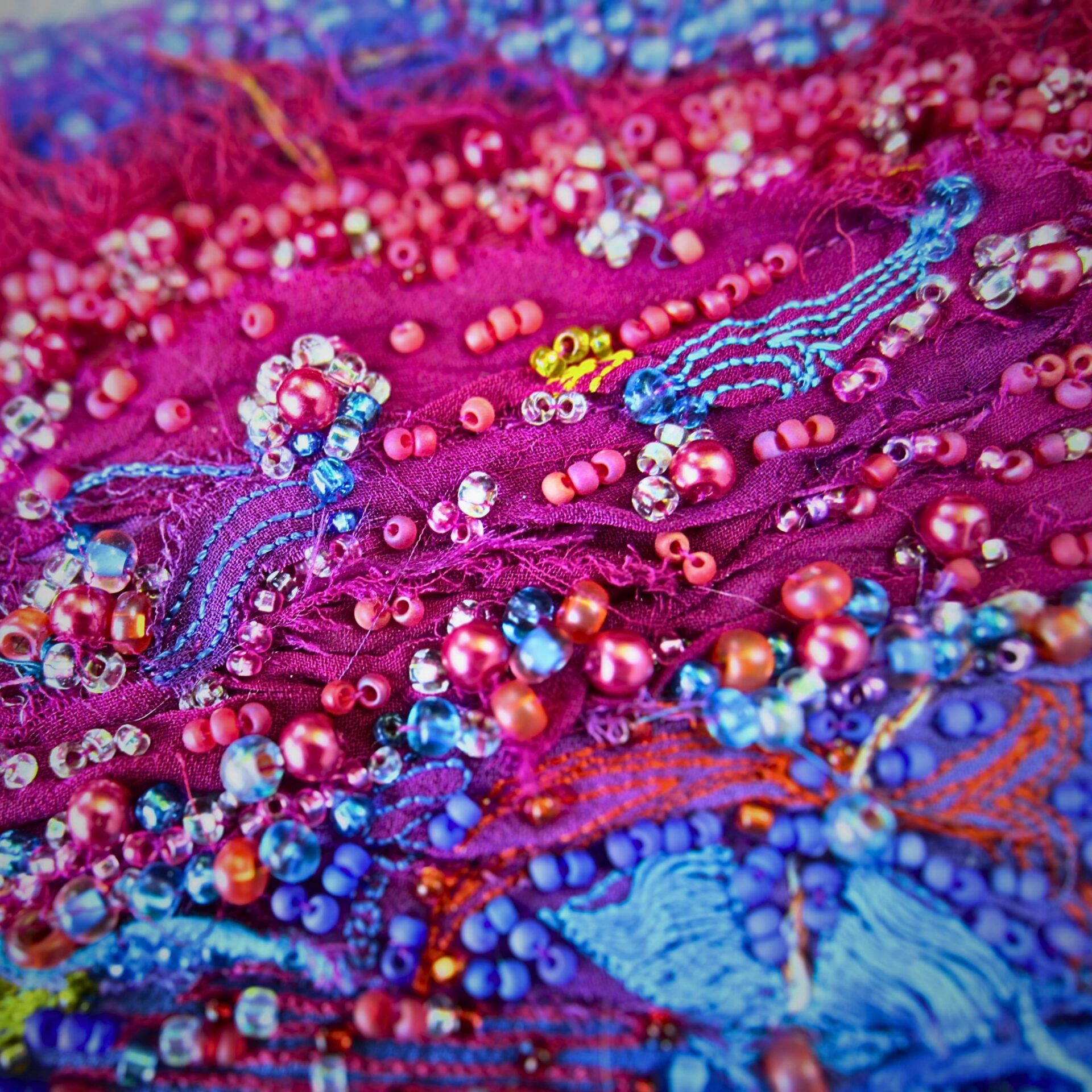 Colourful beaded textile art detail.