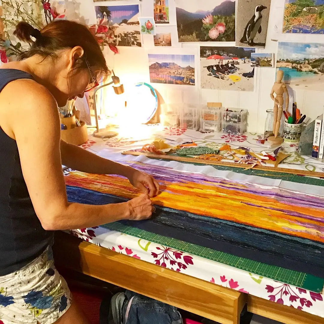 Jackie working in her former home studio, guided by her extensive mood board. 