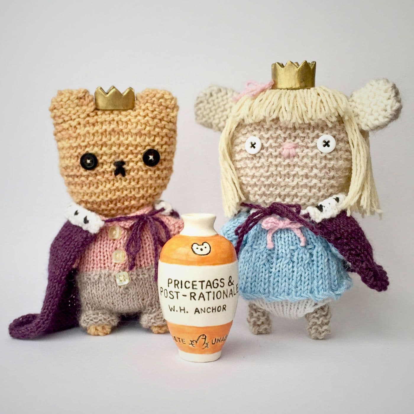 Two knitted dolls with a small vase