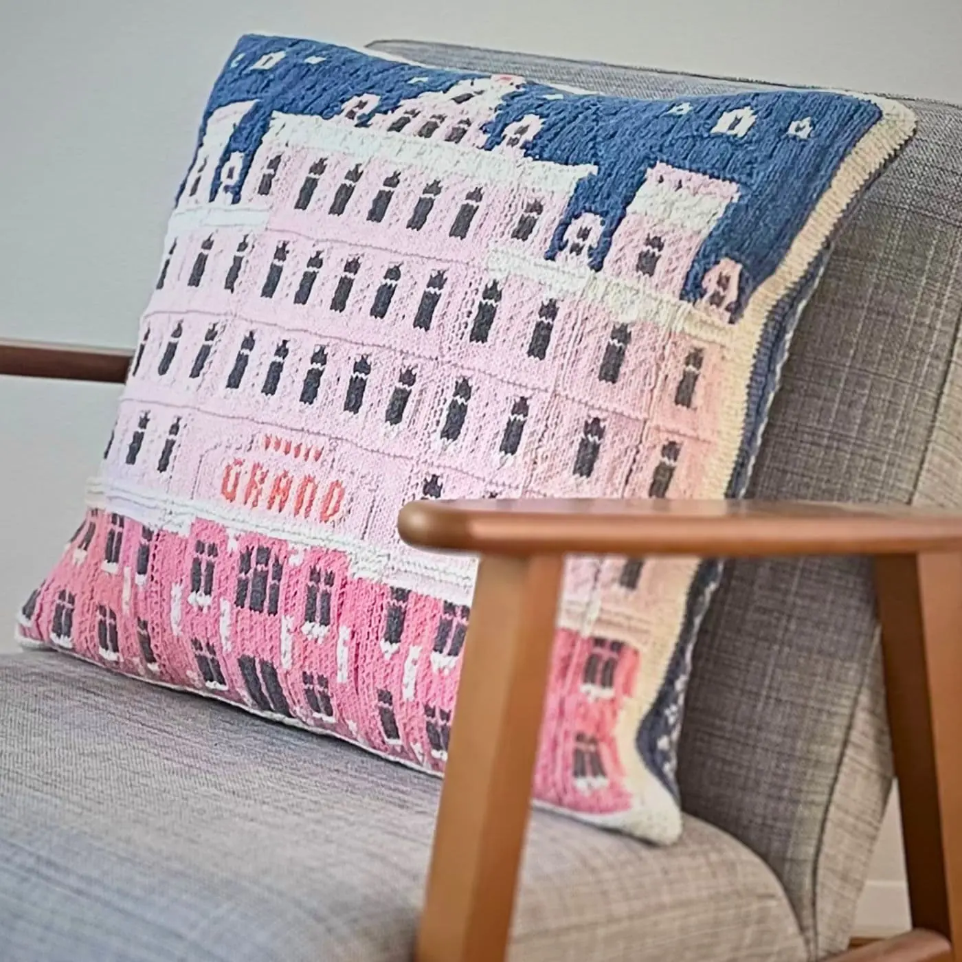 A picture of 'The Grand Budapest hotel' cushion on an armchair