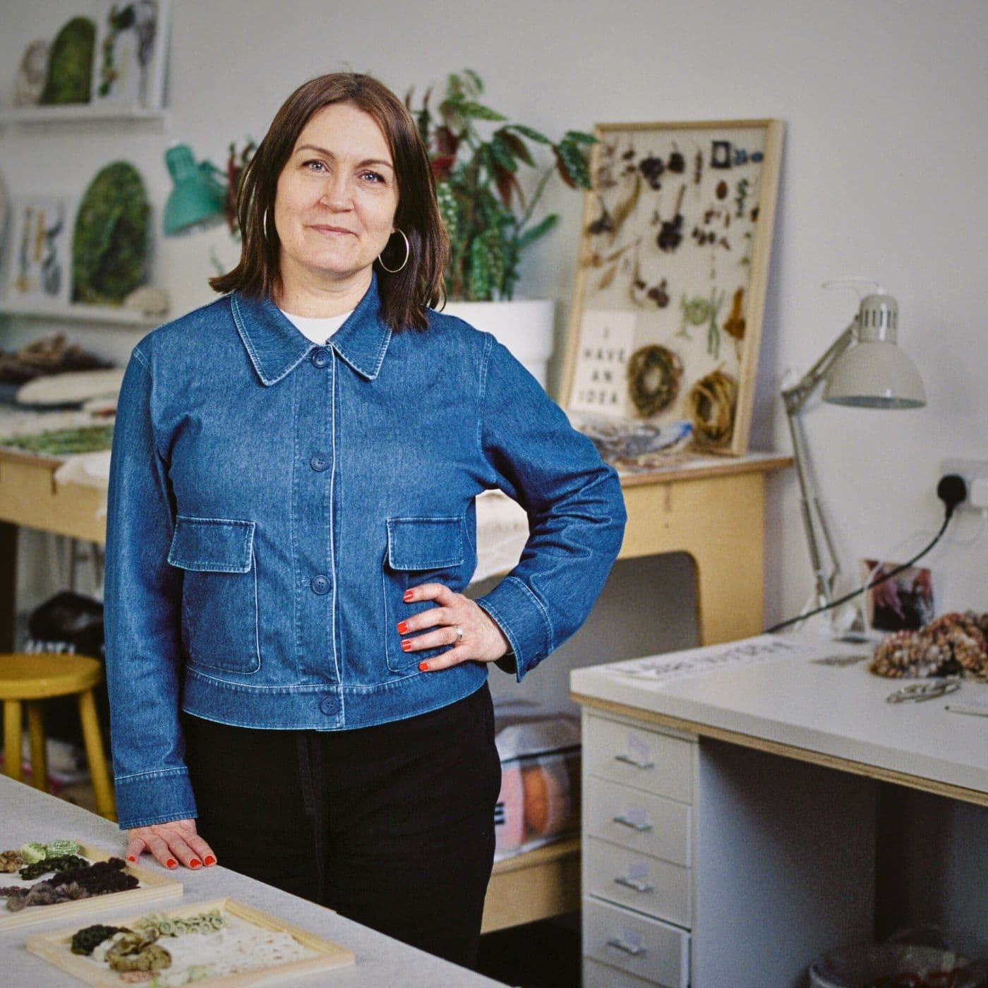 Mixed Media Artist Julia Wright standing in her studio.
