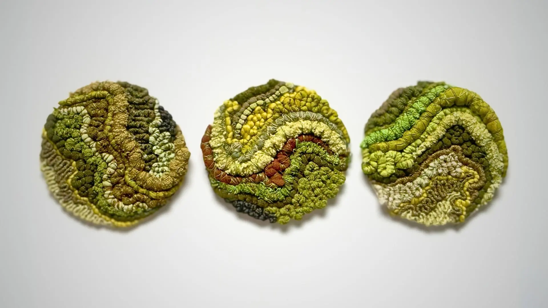 a group of green textiles with different textures through cotton & linen.