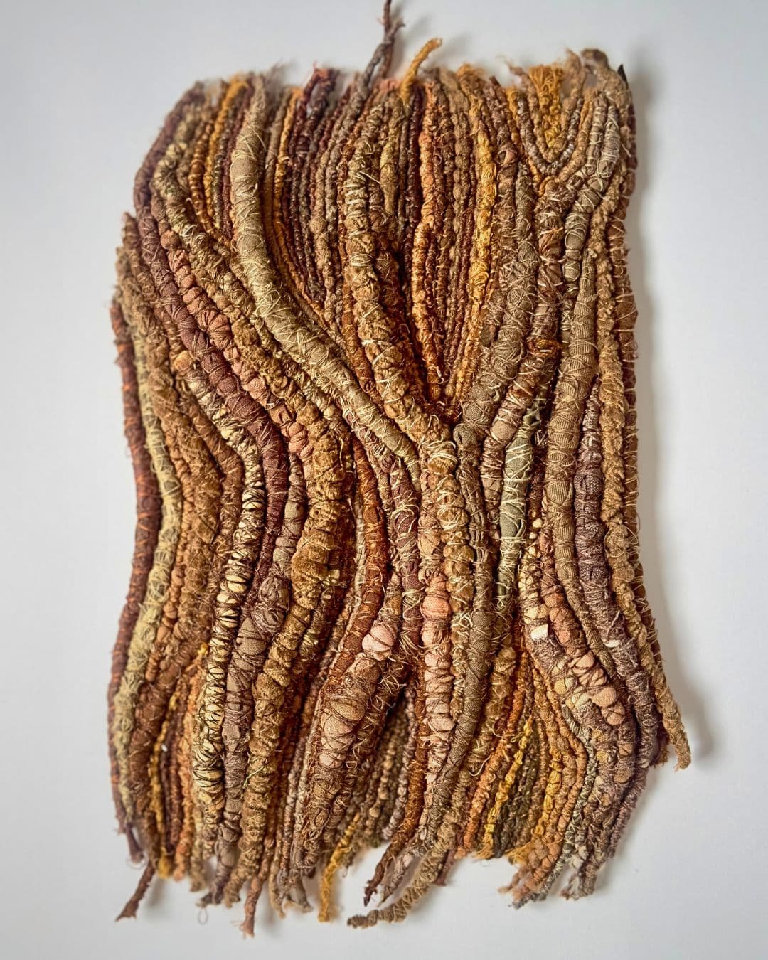 A textile artwork of bark using cottons, linens and velvet.